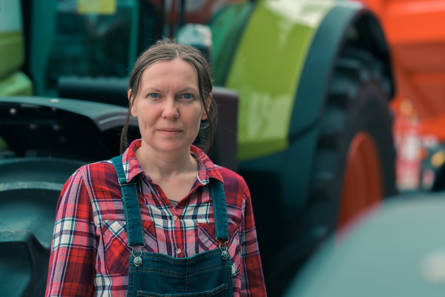 Grower beside farm machinery
